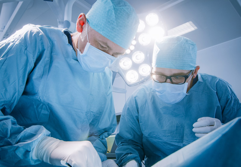 Two-surgeons-performing-sacral-neuromodulation-in-operating-room Two-surgeons-performing-sacral-neuromodulation-in-operating-room